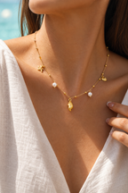 Cetara shell necklace worn on sun-warmed skin