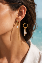 Asymmetrical pearl earrings worn