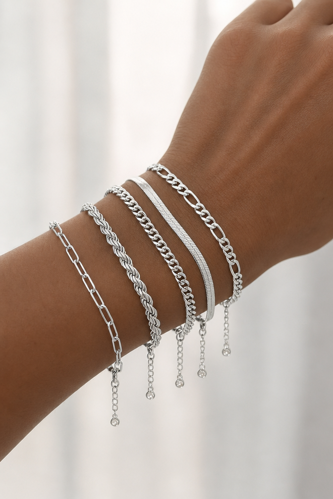 All five silver chain bracelets stacked on a wrist
