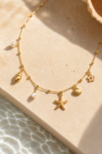 Macro detail of gold shell charms and pearls