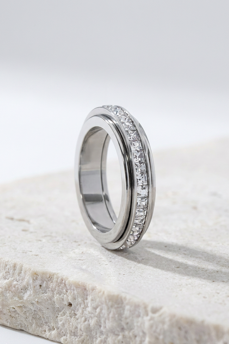Silver Calma spinner ring on limestone