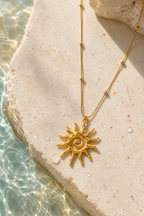 Water beading on the gold pendant