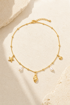 Cetara shell necklace in 18k gold with starfish, conch and pearl charms