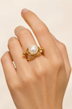 Atrani Orbit Ring worn on a hand against a cream backdrop