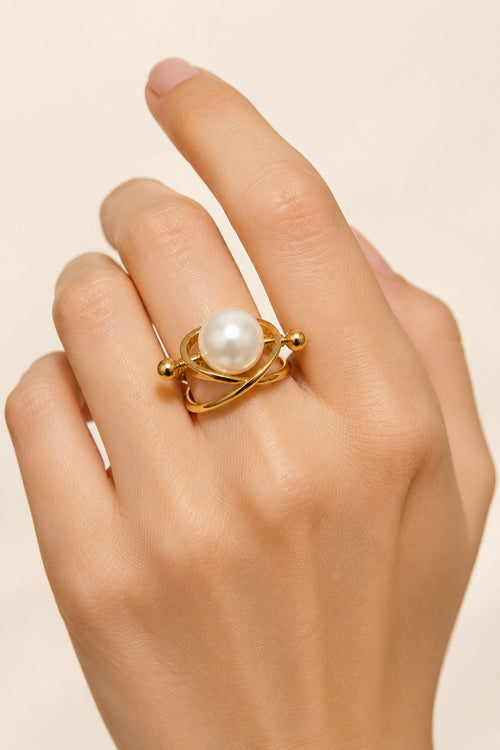 Atrani Orbit Ring worn on a hand against a cream backdrop