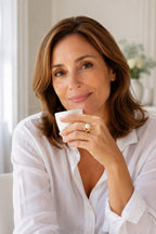 Woman holding an espresso cup wearing the Atrani Orbit Ring