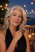 Woman in a black evening top wearing the Atrani Orbit Ring at dusk
