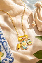 Limone charm necklace flat lay among lemons