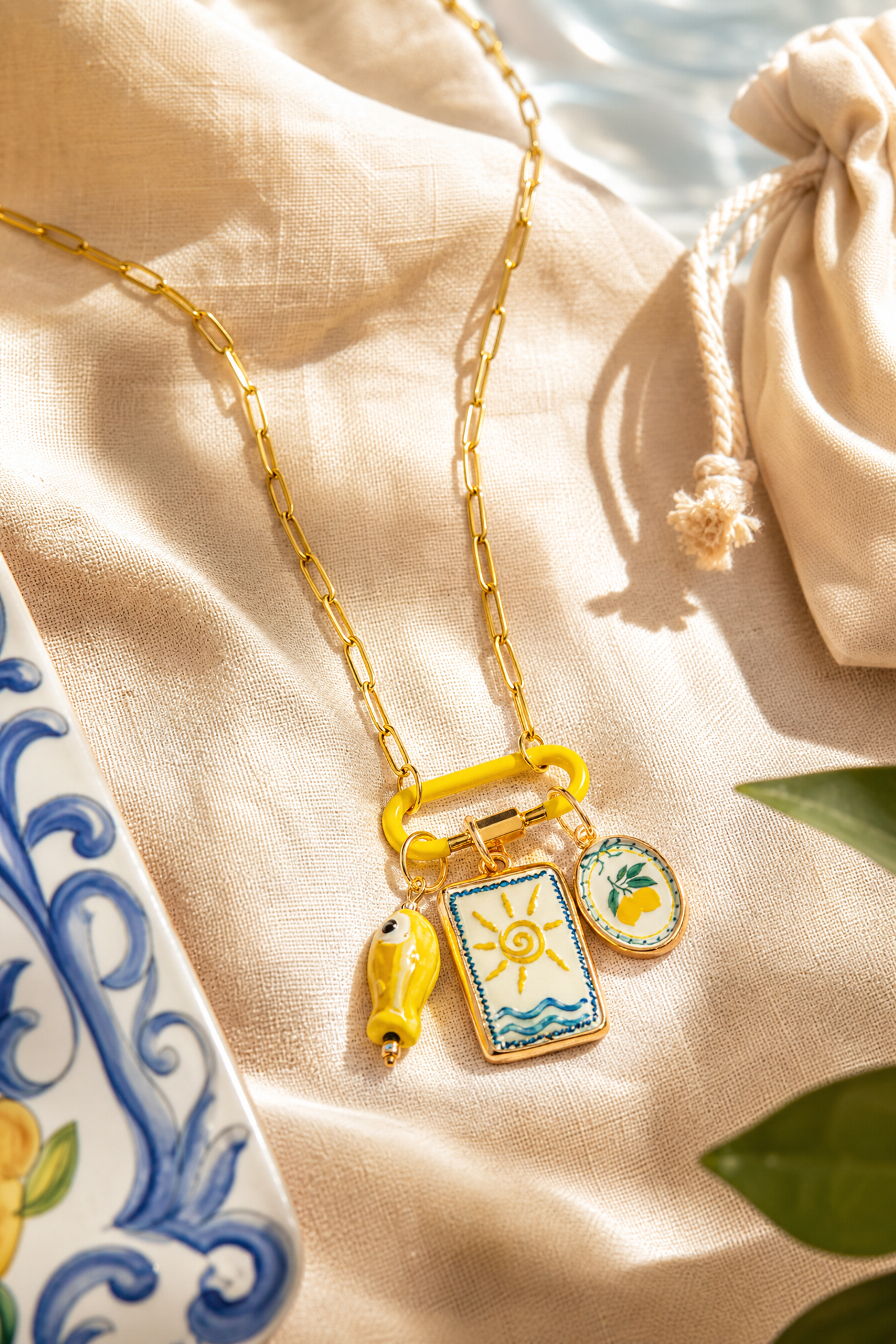 Limone charm necklace flat lay among lemons