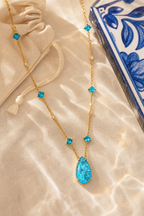 Marea wave necklace flat lay