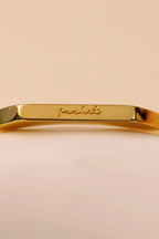 Close up of the cursive engraving on the flat top bar of the Basta Band