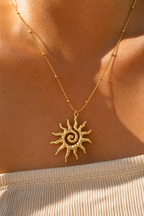 Macro detail of the hammered spiral sun pendant