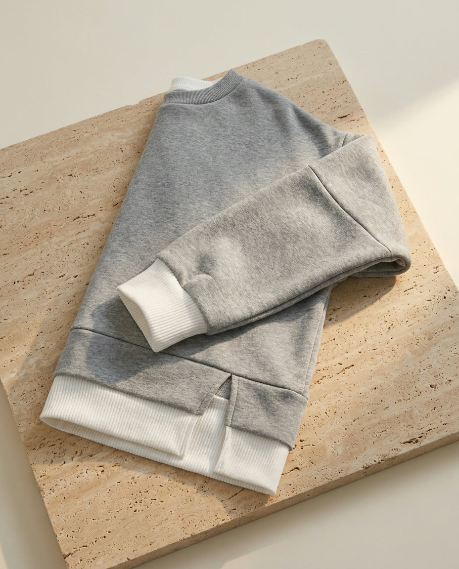 Bruma layered sweatshirt on warm travertine stone