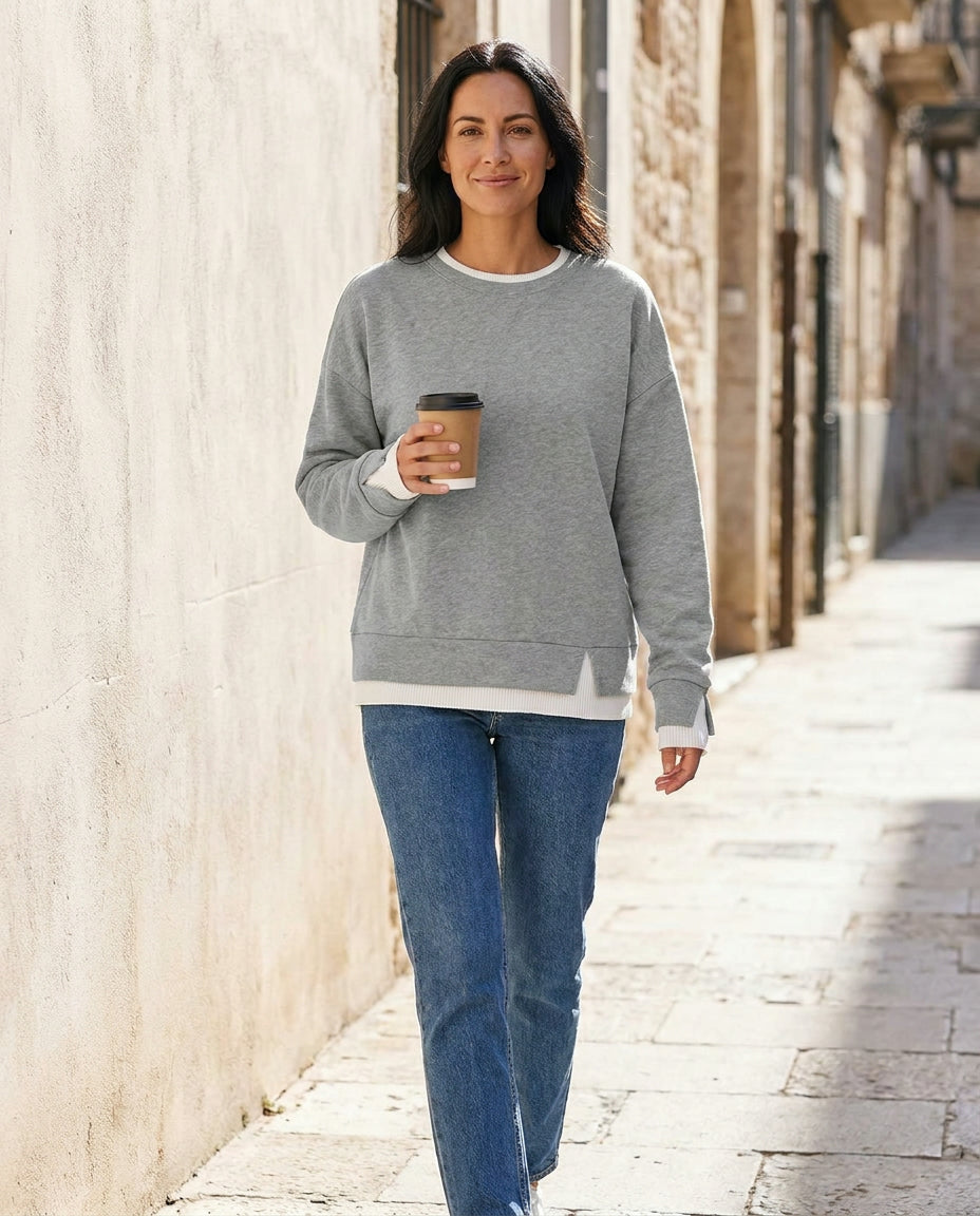 Woman wearing the Bruma layered sweatshirt with a white tee