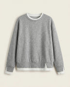 Bruma layered sweatshirt on a plain off-white background