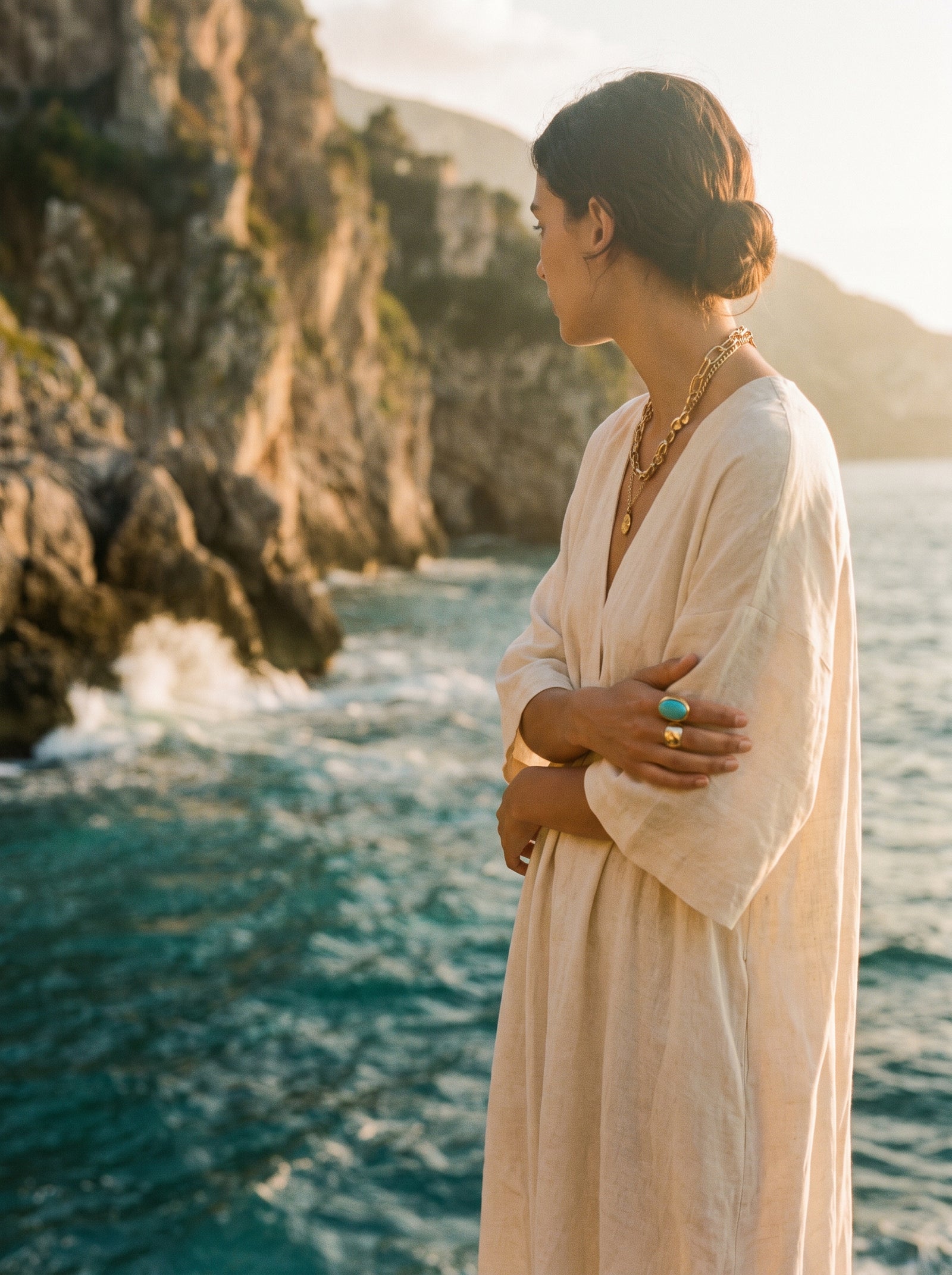Turquoise Mediterranean waves against the Amalfi cliffs at golden hour