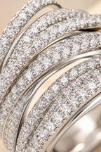 Macro of the Abbraccio crossing pave bands showing rows of tiny crystal stones