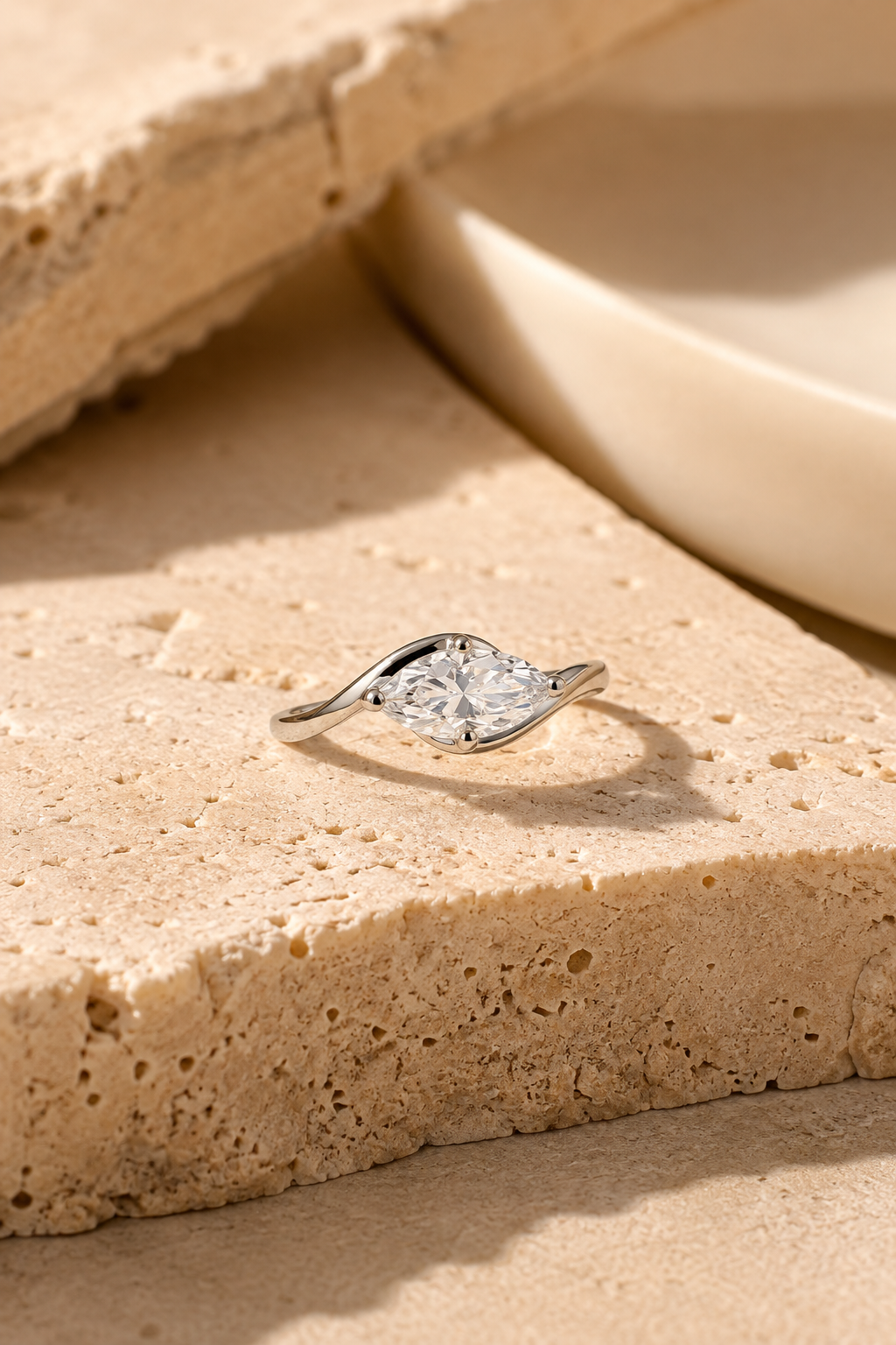 Onda marquise ring on travertine stone