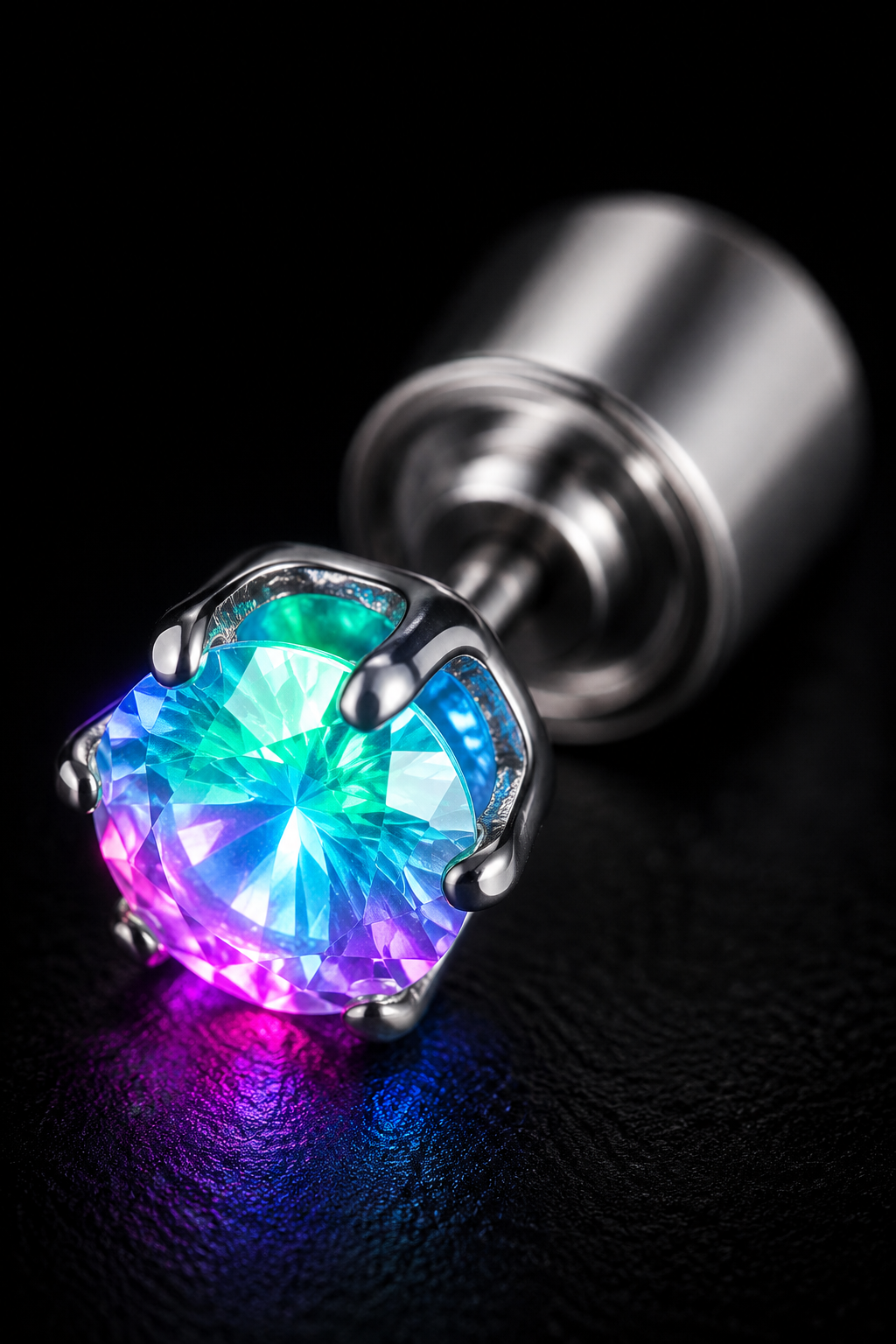 Macro of a single Lucciola stud, the claw-set crystal lit from within with rainbow LED colour