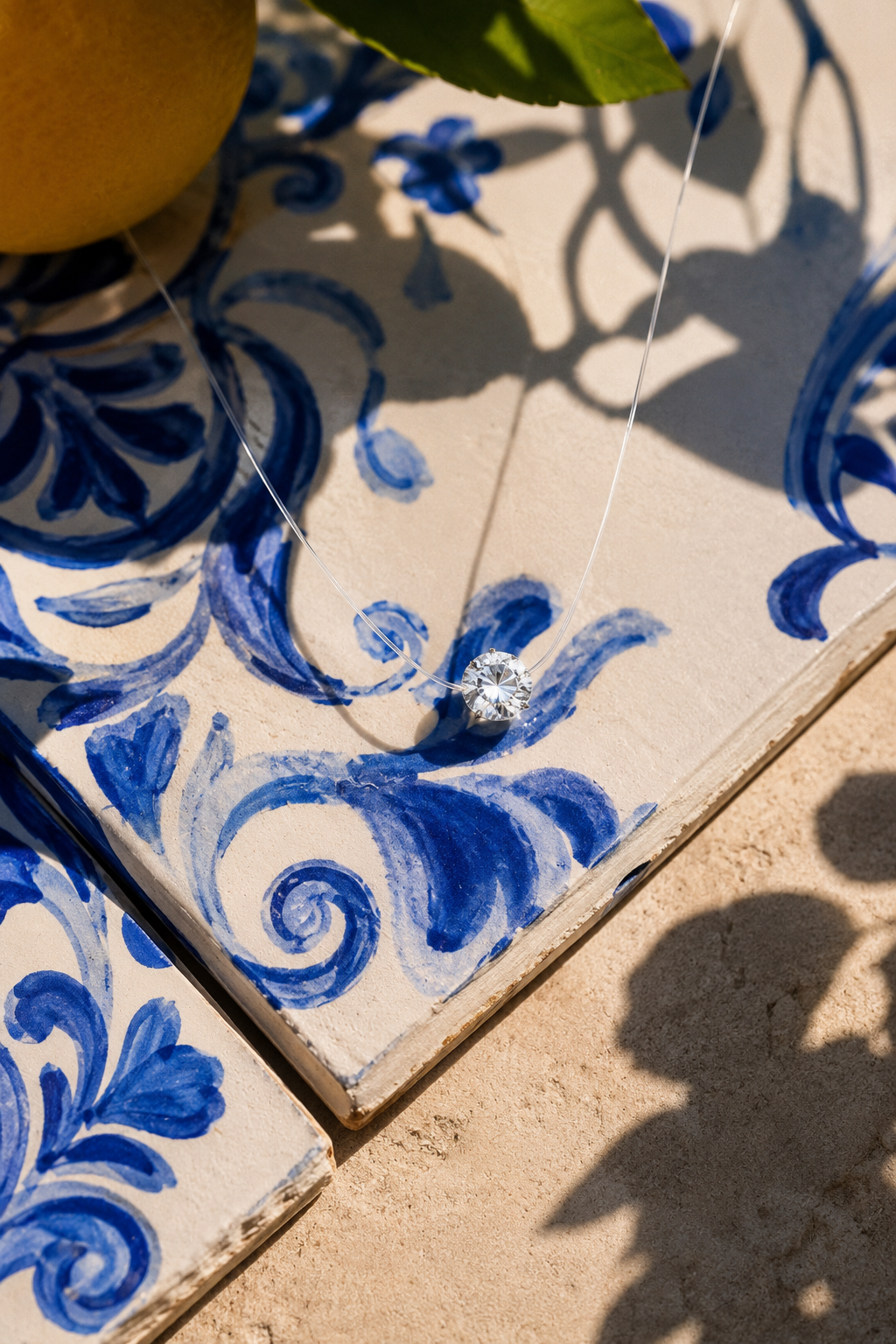 Goccia crystal necklace on a hand-painted majolica tile