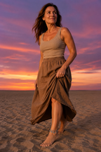 Woman walking on evening sand at dusk wearing the Incanto bracelet as an anklet