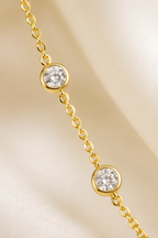 Macro detail of two bezel-set crystal stations on the Stellina cable chain