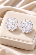 Ortensia crystal bloom studs on a cream velvet cushion