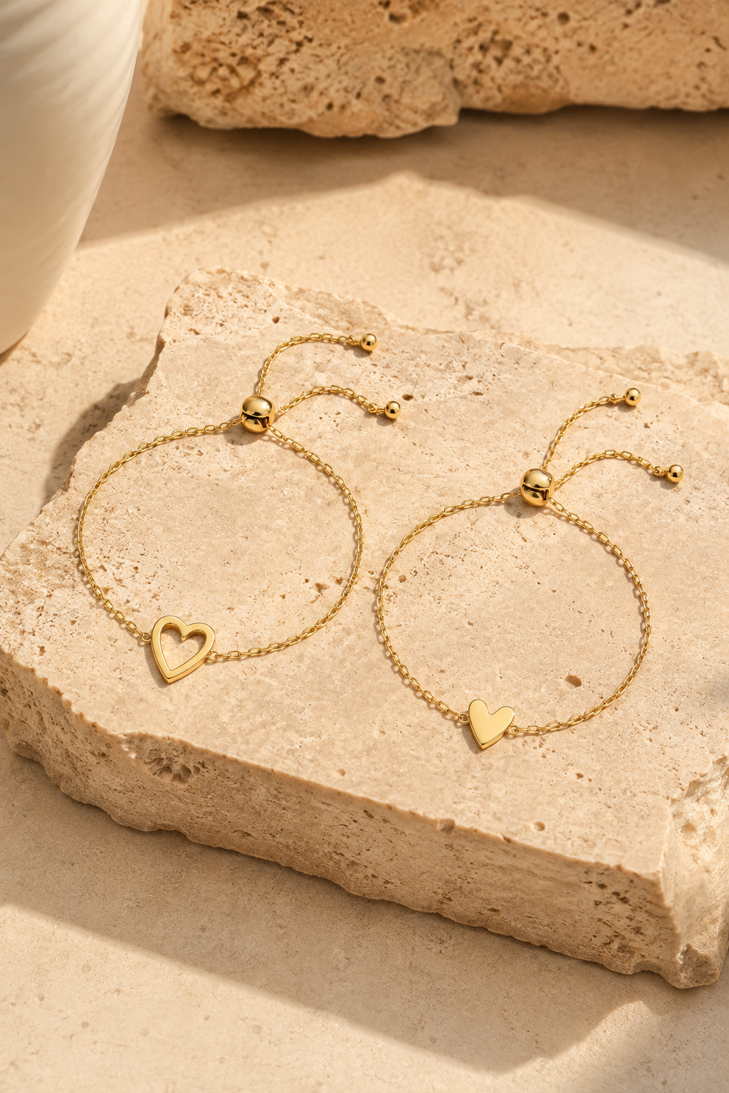 Sorella heart bracelet set, both bracelets on travertine stone