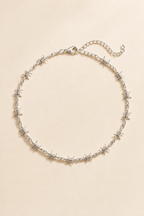 Spina barbed choker in silver on a cream background