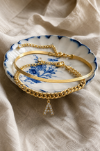 Marea anklet set draped over an Italian ceramic dish on linen