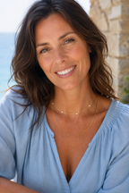 The Stellina choker layered over a longer gold chain with a pale blue blouse