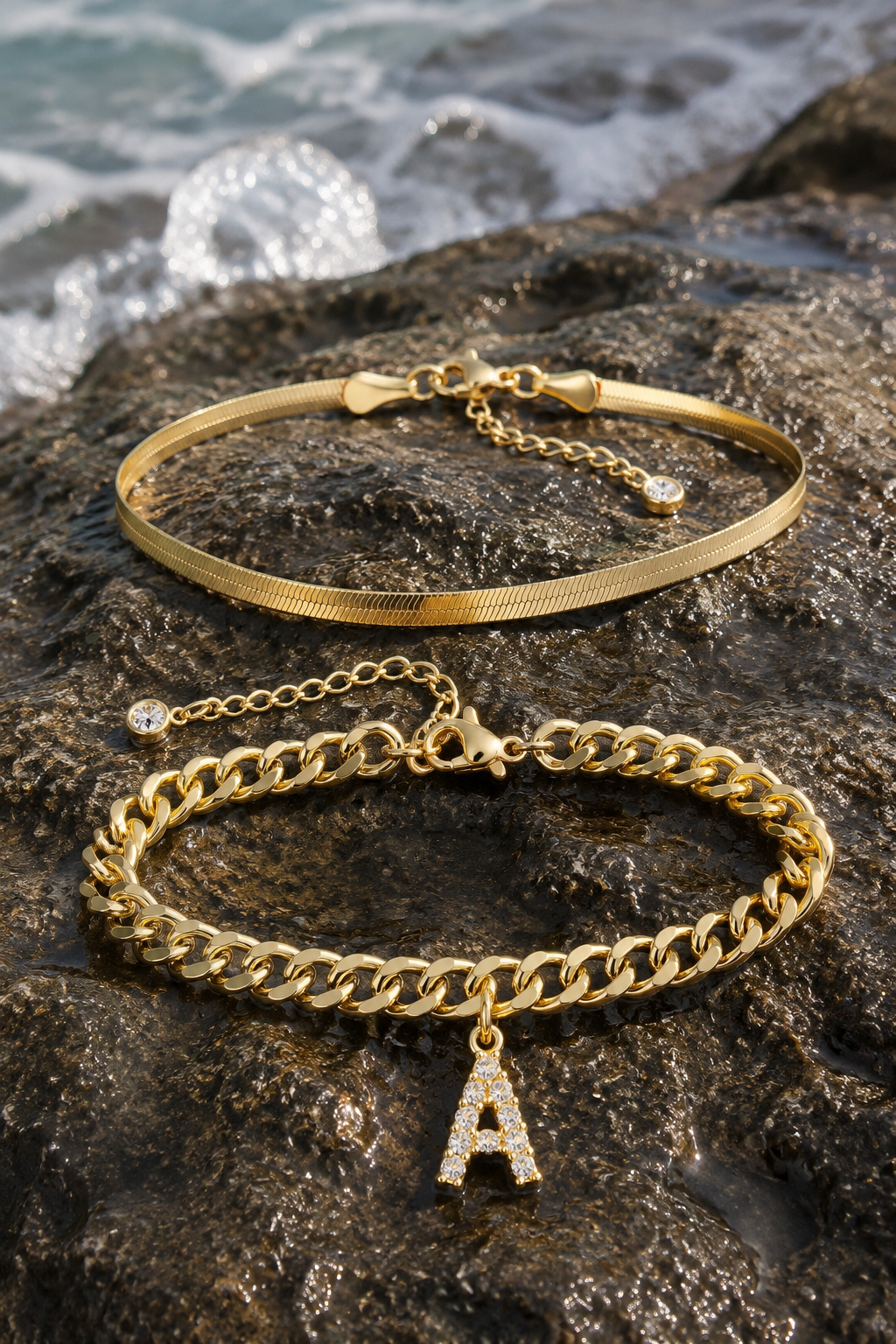 Marea anklet set on wet sea-washed stone with water beading on the gold