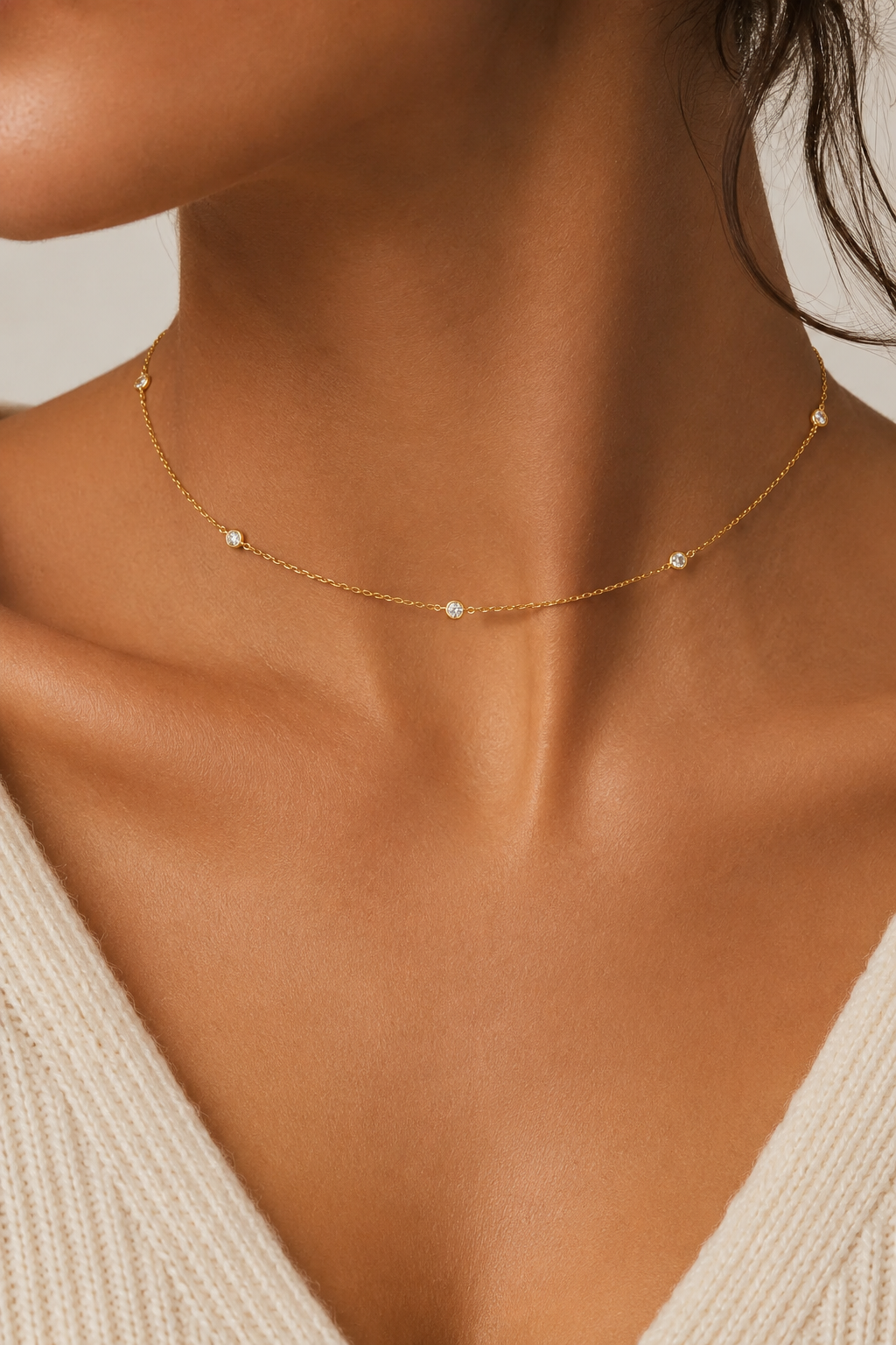 Close crop of the Stellina choker worn at the collarbone over a cream knit top
