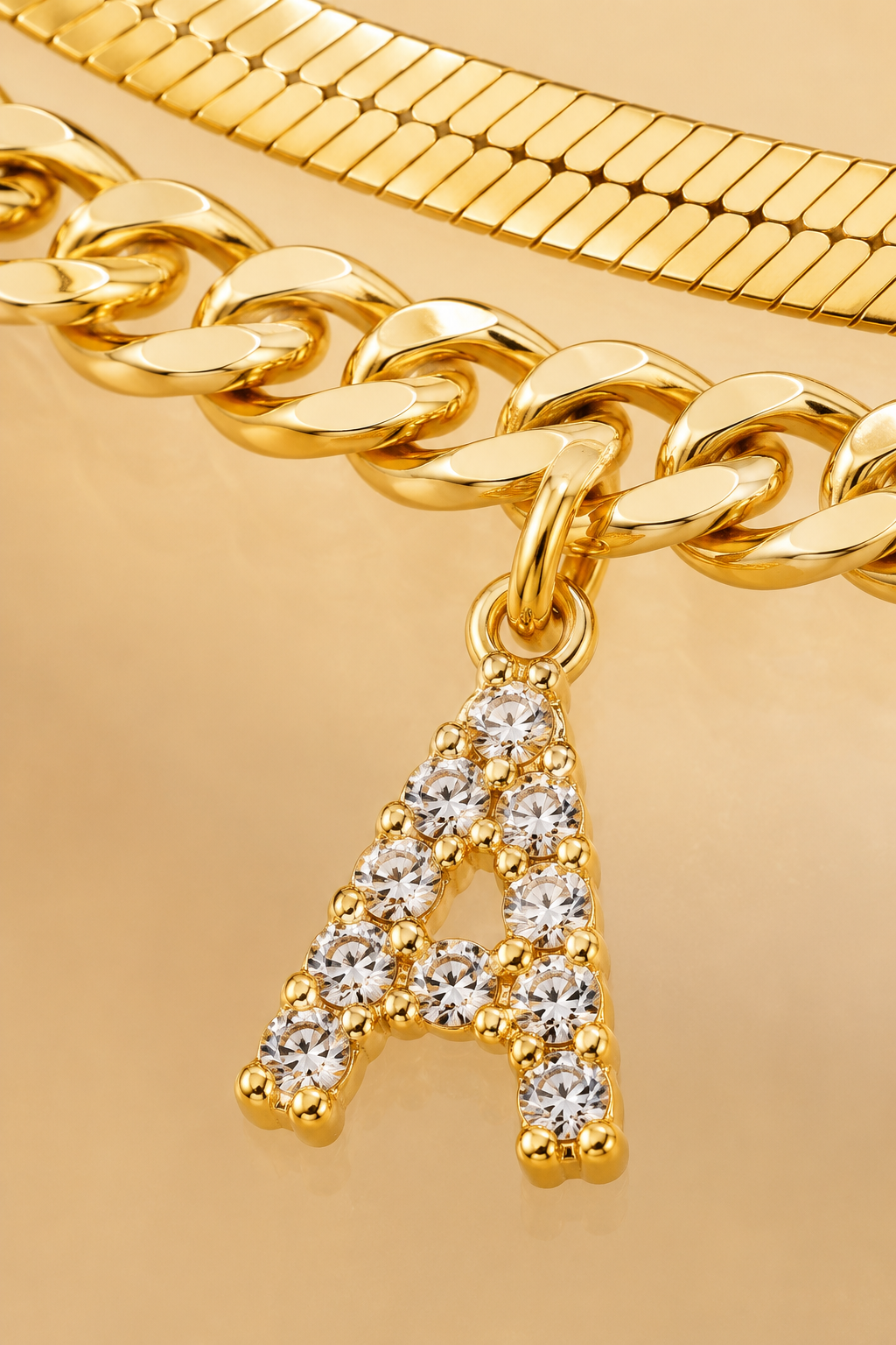 Macro close-up of the crystal-set initial charm on the Marea anklet