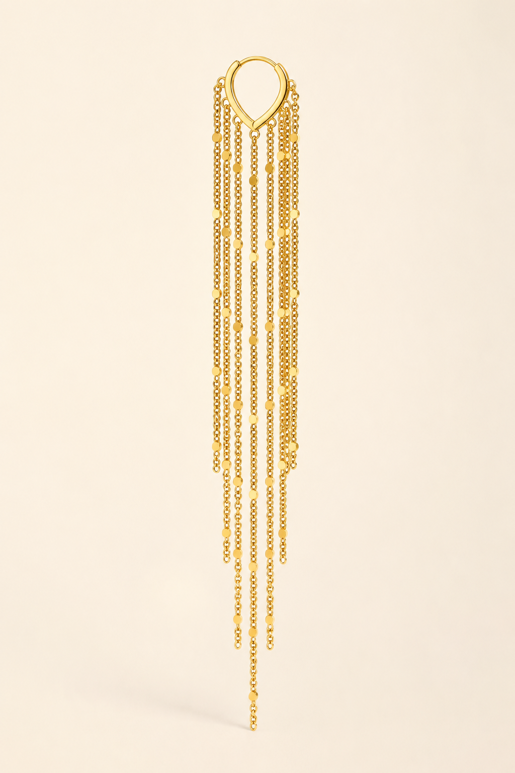 Single Cascata tassel earring on a cream background