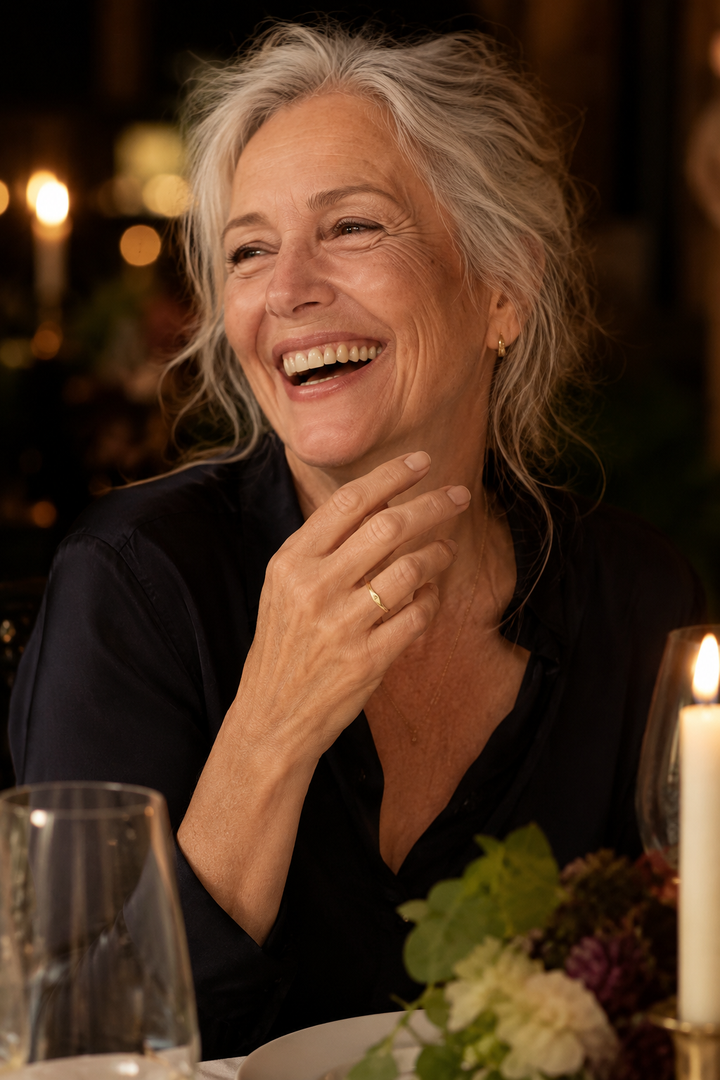 Woman laughing at dinner wearing the Lettera initial ring