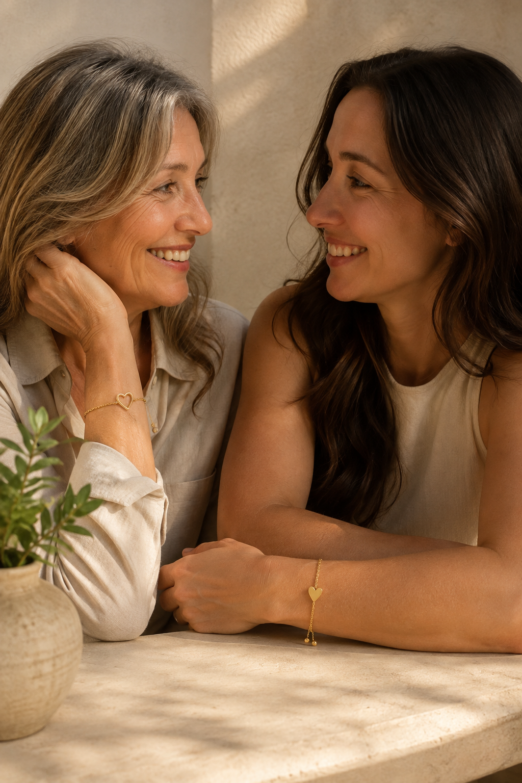 Two women wearing one bracelet each from the matching set