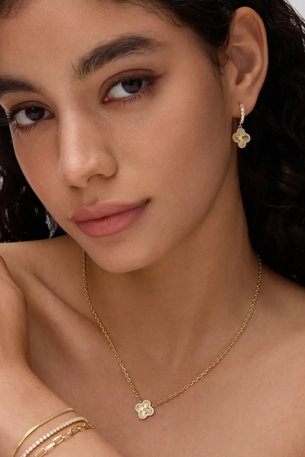 Fortuna clover earring worn with a matching clover necklace
