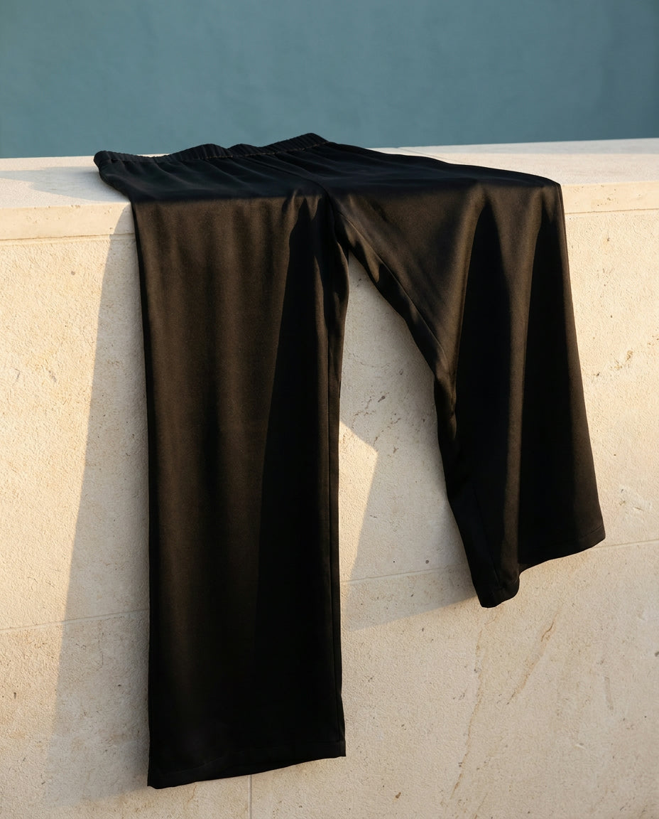 Luna satin pant draped over a limestone ledge