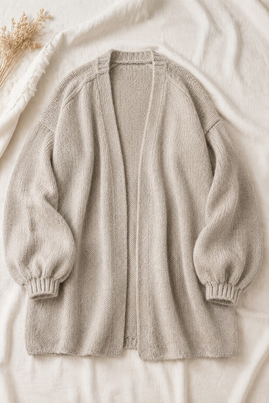 Nuvola oversized open-front cardigan laid flat on cream linen