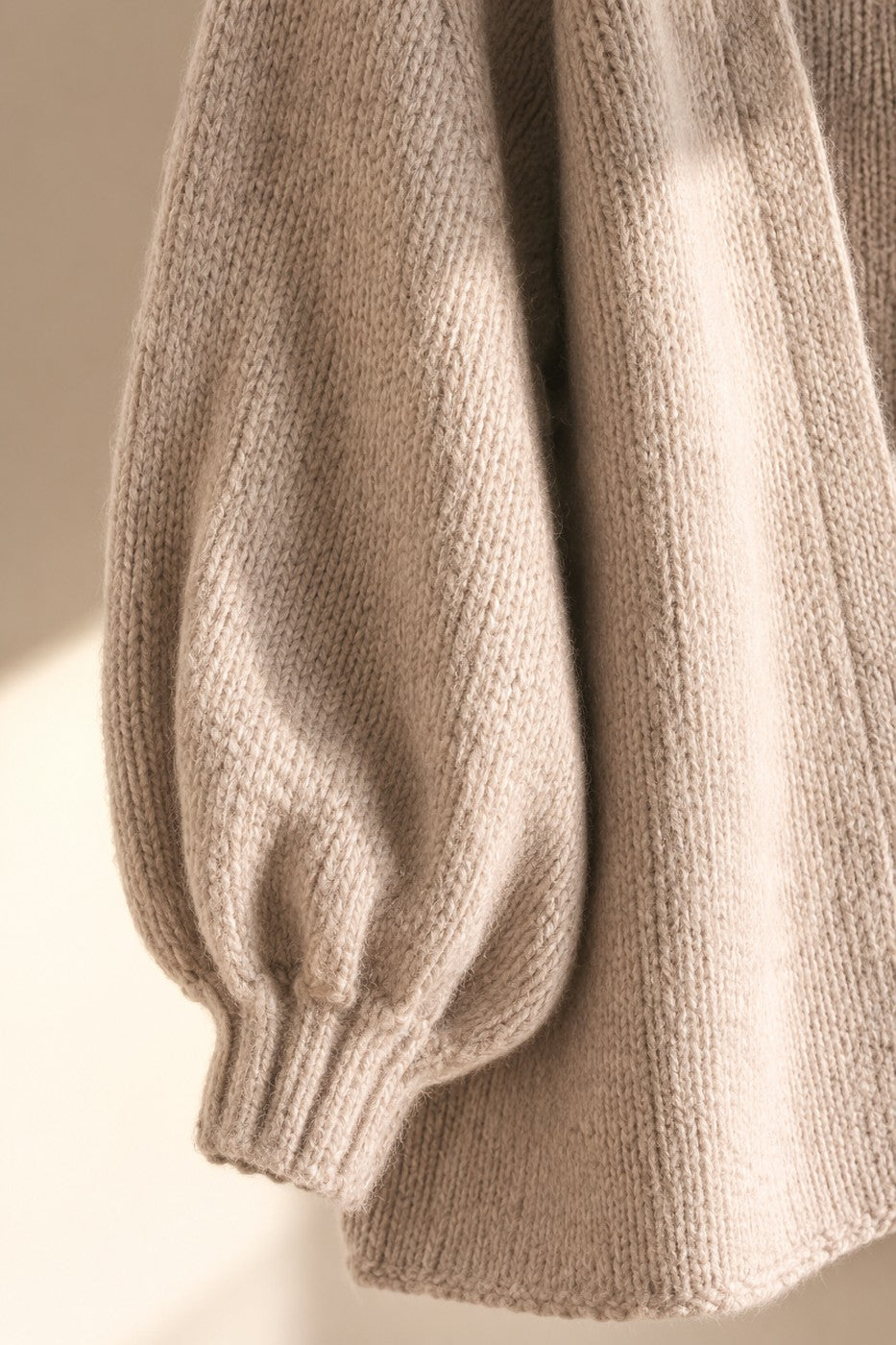 Close detail of the gathered lantern cuff and brushed knit