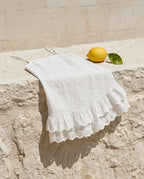 Praiano eyelet romper draped over a limestone ledge