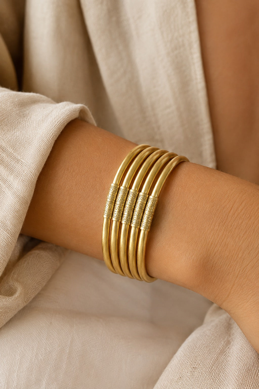 Six Quiete bangles stacked on a woman's wrist