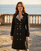 Woman wearing the Ravello trench coat belted on a stone terrace