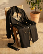 Ravello trench coat draped over a caned chair