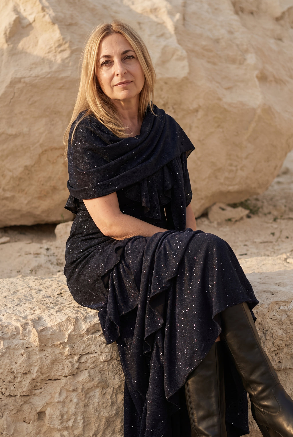 Scintilla shimmer dress in black, seated with the scarf