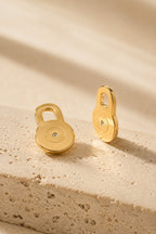 Solleva gold lobe lifter earring backs on warm travertine stone